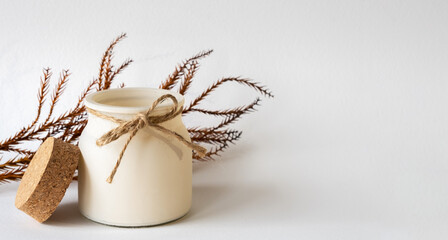 Aroma candle on white background, pine branch decor elements, cozy home and relax concept, banner with space for text