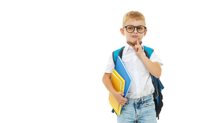 Back to school. Funny little boy from elementary school with a book, a backpack and glasses on a white background. Laughs merrily. Preparation for school. Concept of early development