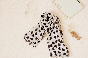 Fashion look with black and white scarf on white background. Flat lay, top view.