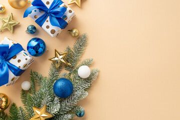 New Year concept. Top view photo of pine branch in frost decorated with star ornaments white blue gold baubles and stylish gift boxes with ribbon bows on isolated beige background with empty space