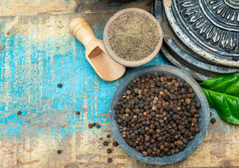 Indian spices collection, dried black peppercorns and another spices in clay bowls