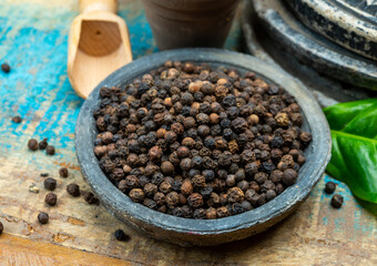 Indian spices collection, dried black peppercorns and another spices in clay bowls