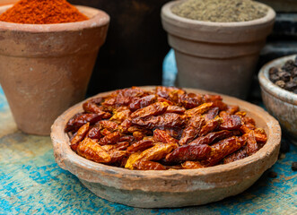Colorful ground spicy chili peppers , pimento and curcuma is clay pots close up