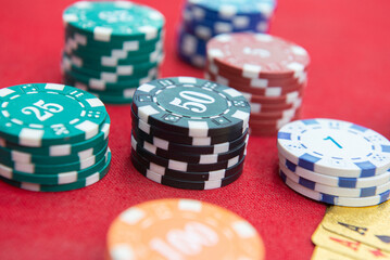 Four of aces near stacks of chips on a red felt table