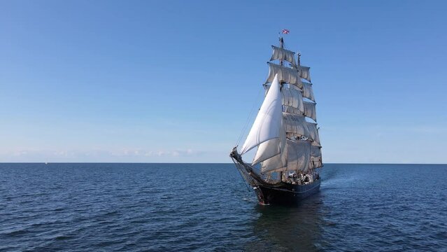 Aerial rotating shot of the bow of a sailing tall ship