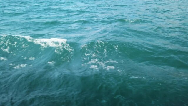 Splashing wake after boat on beautiful blue sea 4K slow motion