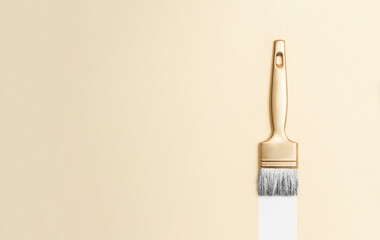Gold color paintbrush on beige background. Horizontal creative theme poster, greeting cards, headers, website and app