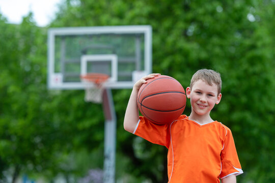 Boy Playing Basketball On A Park Court. Concept Of A Sports Lifestyle, Training, Camp, Leisure, Vacation. Horizontal Sport Theme Poster, Greeting Cards, Headers, Website And App