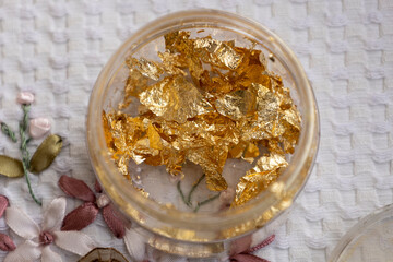 container with edible gold for dessert decoration, extravagant ingredient texture, cooking