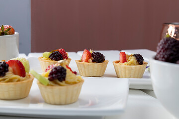 sweet cupcakes with cream and citrus fruits, appetizers for catered event, gourmet food, studio food