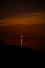dark, smoky sunset over water
