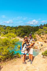 Vacation concept, A family with their child at Playa Salada and Saladeta on the coast of Ibiza....