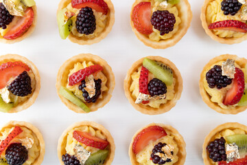 food texture on wallpaper, delicious sweet appetizers, catering service with cupcakes with fruits in studio