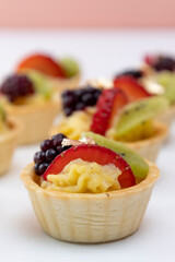 catering service with cakes with fruits in the studio, delicious snack, background with an approach to fresh food