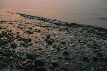 rocky Pacific Northwest beach during a smoky sunset