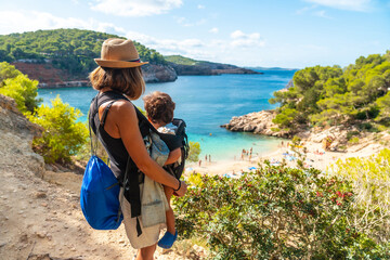 Mother with her son on the paradisiacal beaches on the coast of Ibiza, Playa Salada and Saladeta. Balearic