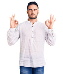 Young handsome man wearing casual clothes relax and smiling with eyes closed doing meditation gesture with fingers. yoga concept.