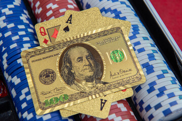 Fototapeta premium Gold playing cards and $100 bill format on poker chips