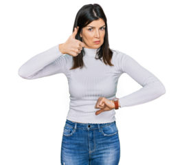 Beautiful brunette woman wearing casual clothes doing thumbs up and down, disagreement and agreement expression. crazy conflict