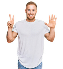 Young irish man wearing casual clothes showing and pointing up with fingers number seven while smiling confident and happy.