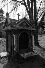 Old stone crypt on the ancient cemetery. Black and white tone