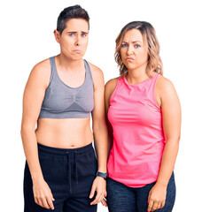 Couple of women wearing sportswear depressed and worry for distress, crying angry and afraid. sad expression.