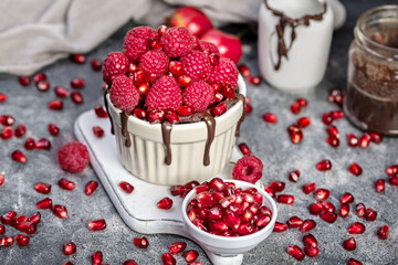 Raspberry mug cake in a red ceramic mug on dark background