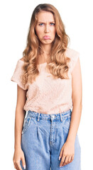 Fototapeta premium Young beautiful caucasian woman with blond hair wearing casual clothes depressed and worry for distress, crying angry and afraid. sad expression.