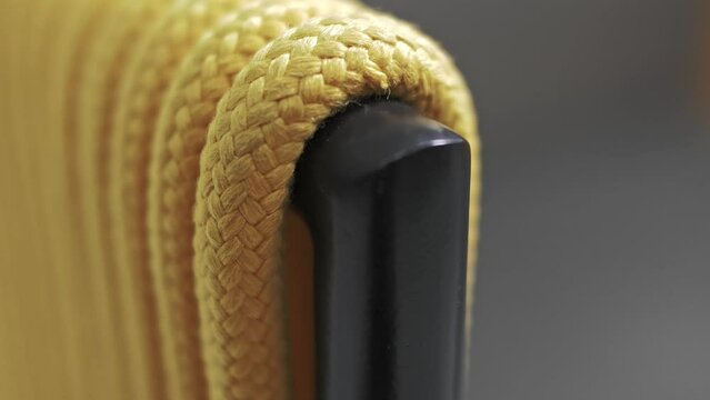 Yellow rope exterior chair armrest and aluminum frame. Close-up 