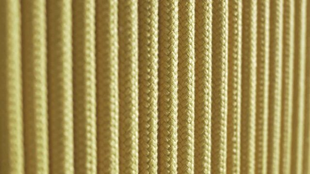 Texture of synthetic cords woven together is yellow. Close-up 