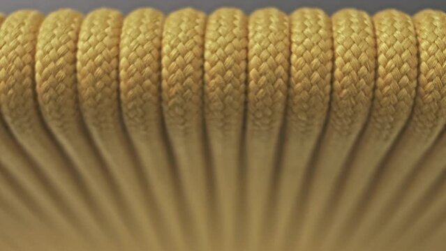 Side of the chair is made of sturdy yellow ropes. Close-up. Macro 