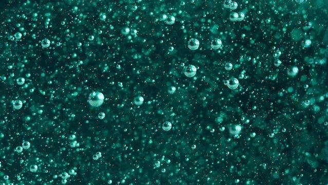 Air bubbles in the soap background. Abstract oxygen bubbles in the sea. Dark teal color trend in 2023. 4K UHD
