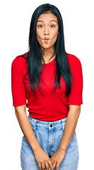 Obraz premium Beautiful hispanic woman wearing casual clothes making fish face with lips, crazy and comical gesture. funny expression.