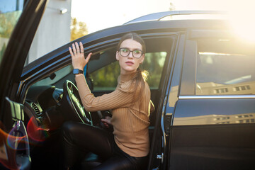 Young confident business lady in glasses in car, active independent woman lifestyle