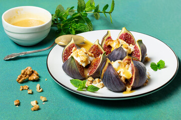 Figs stuffed with cream cheese with honey sauce and walnuts
