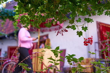 A blurred courtyard and a woman in a pink blouse in the old town in Tallinn, Estonia.