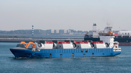 Port of Rotterdam, the Netherlands - 10 05 2022: Heavy load carrier with the cargo of wind farm...