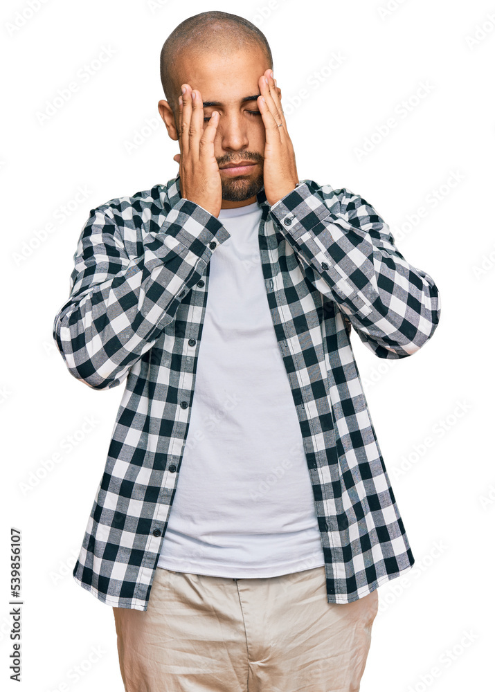 Wall mural Hispanic adult man wearing casual clothes with hand on head for pain in head because stress. suffering migraine.