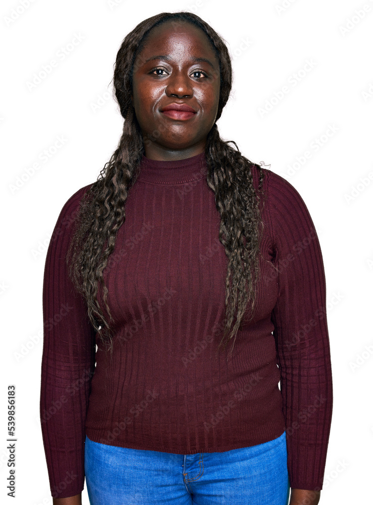 Poster Young african woman wearing casual winter sweater relaxed with serious expression on face. simple and natural looking at the camera.