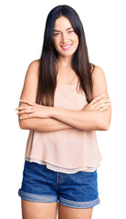 Young beautiful caucasian woman wearing casual clothes happy face smiling with crossed arms looking at the camera. positive person.