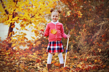 Full length picture of red haired girl collecting autumn leafs