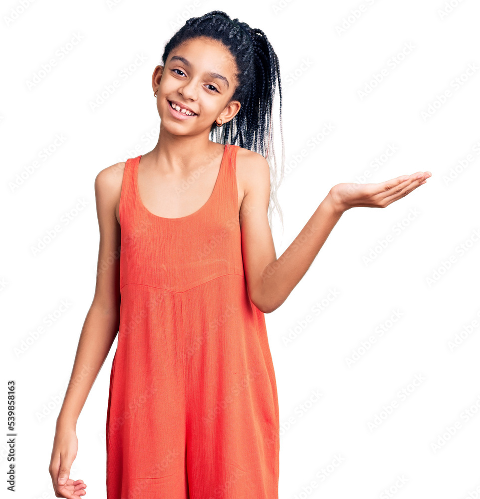 Sticker Cute african american girl wearing casual clothes smiling cheerful presenting and pointing with palm of hand looking at the camera.