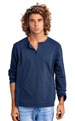 Young hispanic man wearing casual clothes relaxed with serious expression on face. simple and natural looking at the camera.