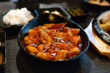 Tteokbokki is a popular Korean snack food. It's made from soft rice cake, fish cake and sweet red chili sauce