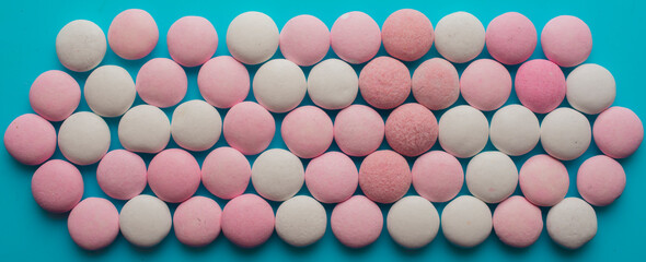 pink and white round candies on a blue background