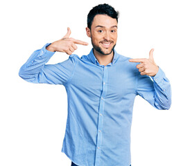 Hispanic man with beard wearing casual business shirt smiling cheerful showing and pointing with fingers teeth and mouth. dental health concept.