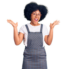 Young african american girl wearing casual clothes celebrating crazy and amazed for success with arms raised and open eyes screaming excited. winner concept