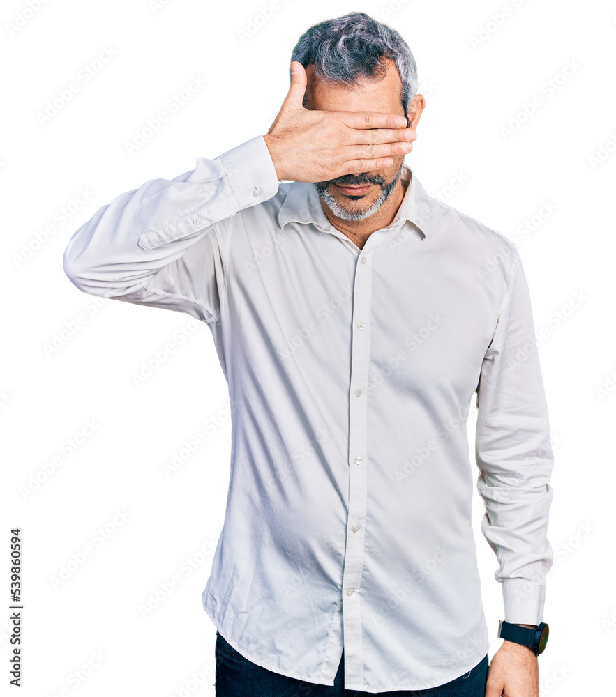 Poster Middle age hispanic with grey hair wearing casual white shirt covering eyes with hand, looking serious and sad. sightless, hiding and rejection concept