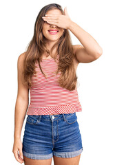 Fototapeta premium Beautiful caucasian young woman wearing casual clothes smiling and laughing with hand on face covering eyes for surprise. blind concept.