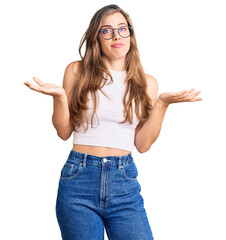 Beautiful caucasian young woman wearing casual clothes and glasses clueless and confused expression with arms and hands raised. doubt concept.